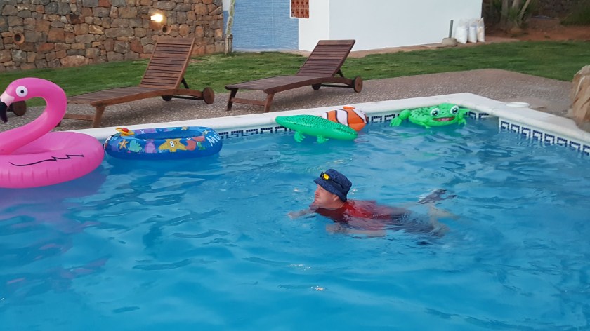 Calv fully clothed in pool